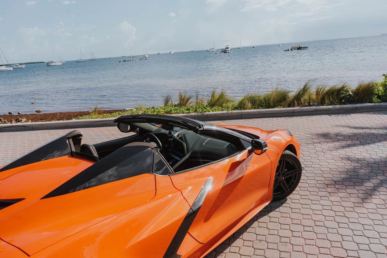 Open cockpit of an orange Corvette C8 convertible