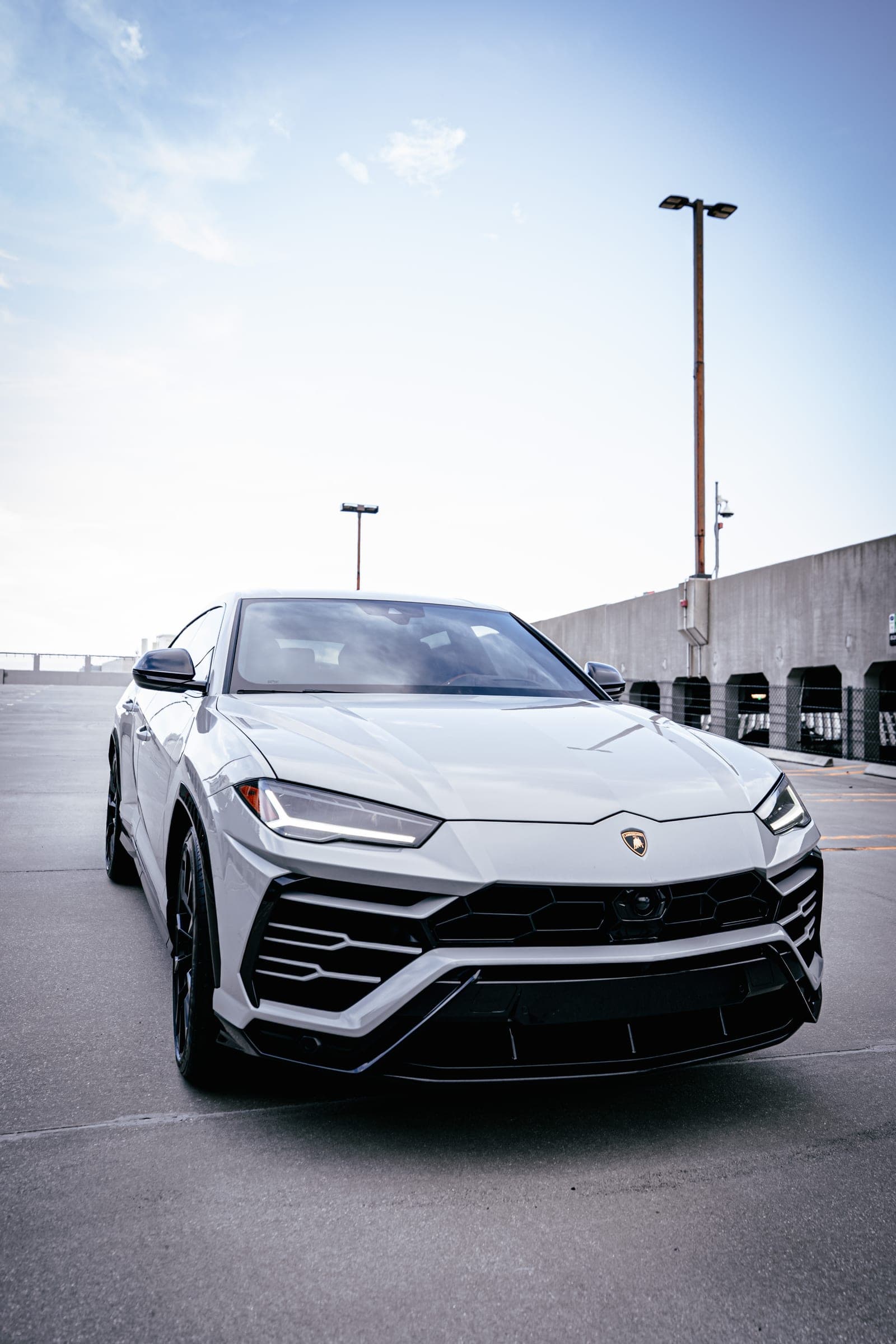 Grey Lamborghini Urus parked at sunset in Miami