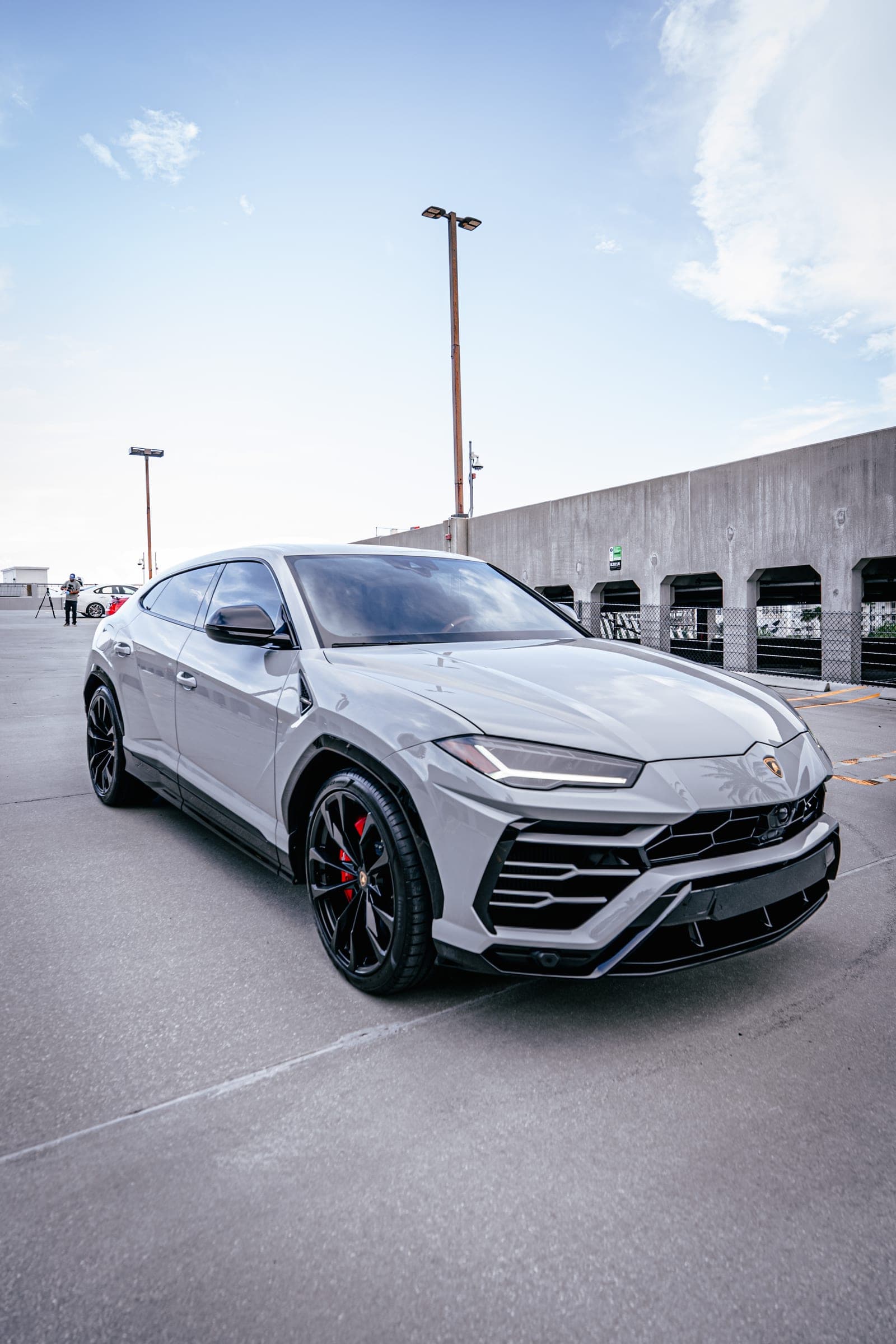 Grey Lamborghini Urus parked on a Miami rooftop deck