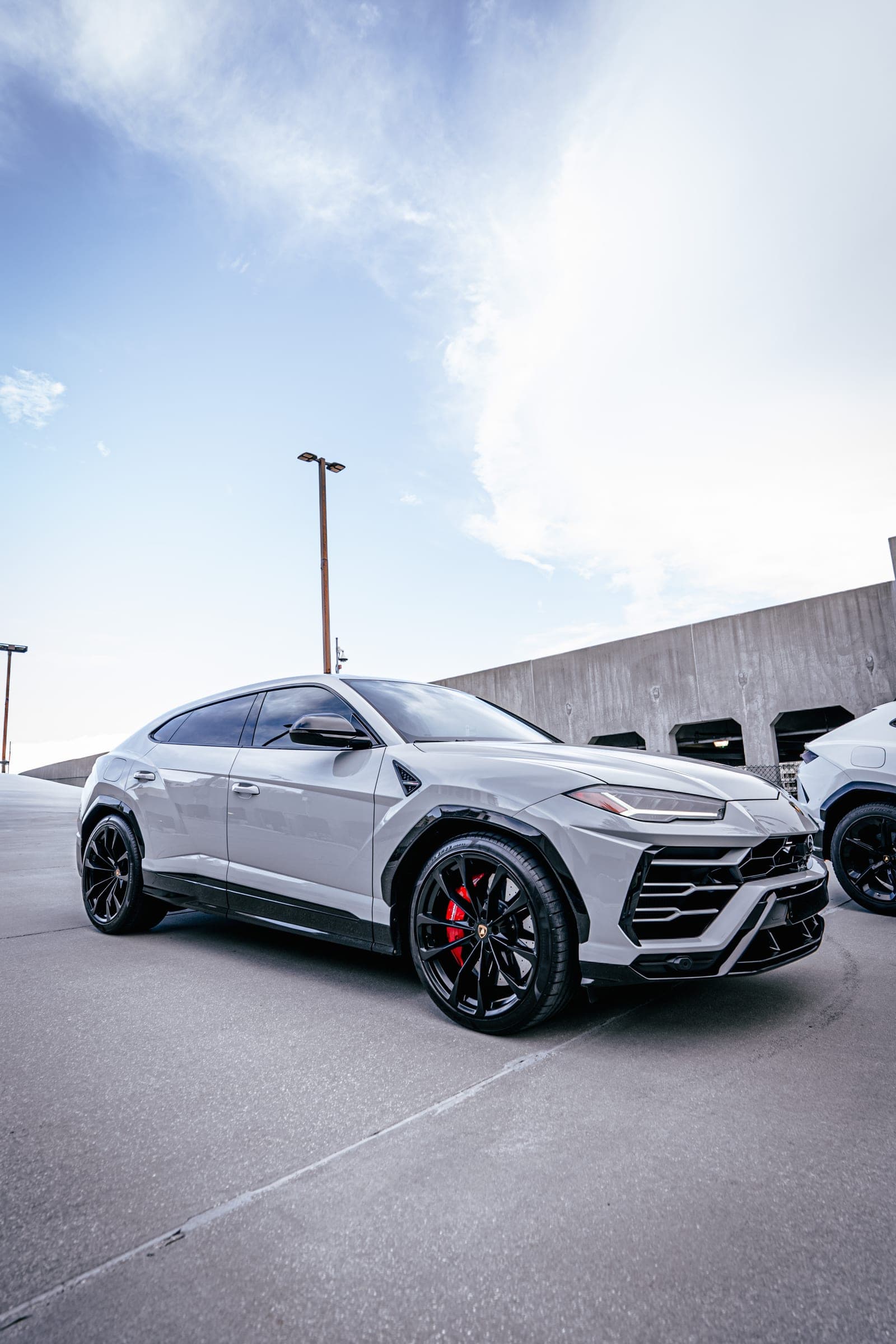 Side profile of a grey Lamborghini Urus on a Miami parking deck