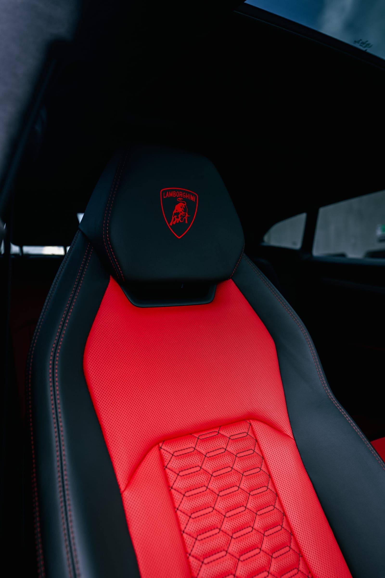 Red leather sport seat with hexagon stitching in a Lamborghini Urus