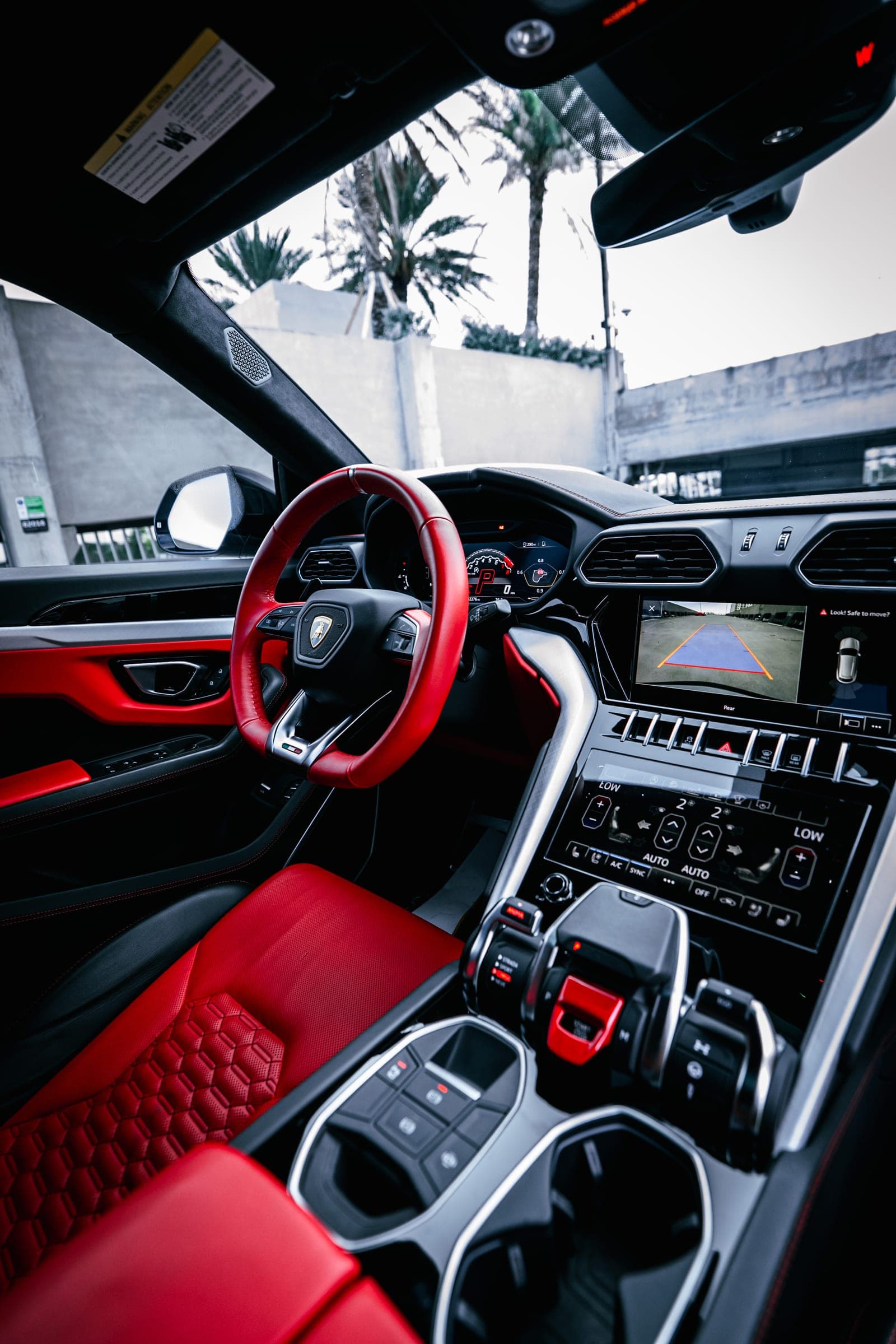 Dashboard, red steering wheel and center console of a Lamborghini Urus