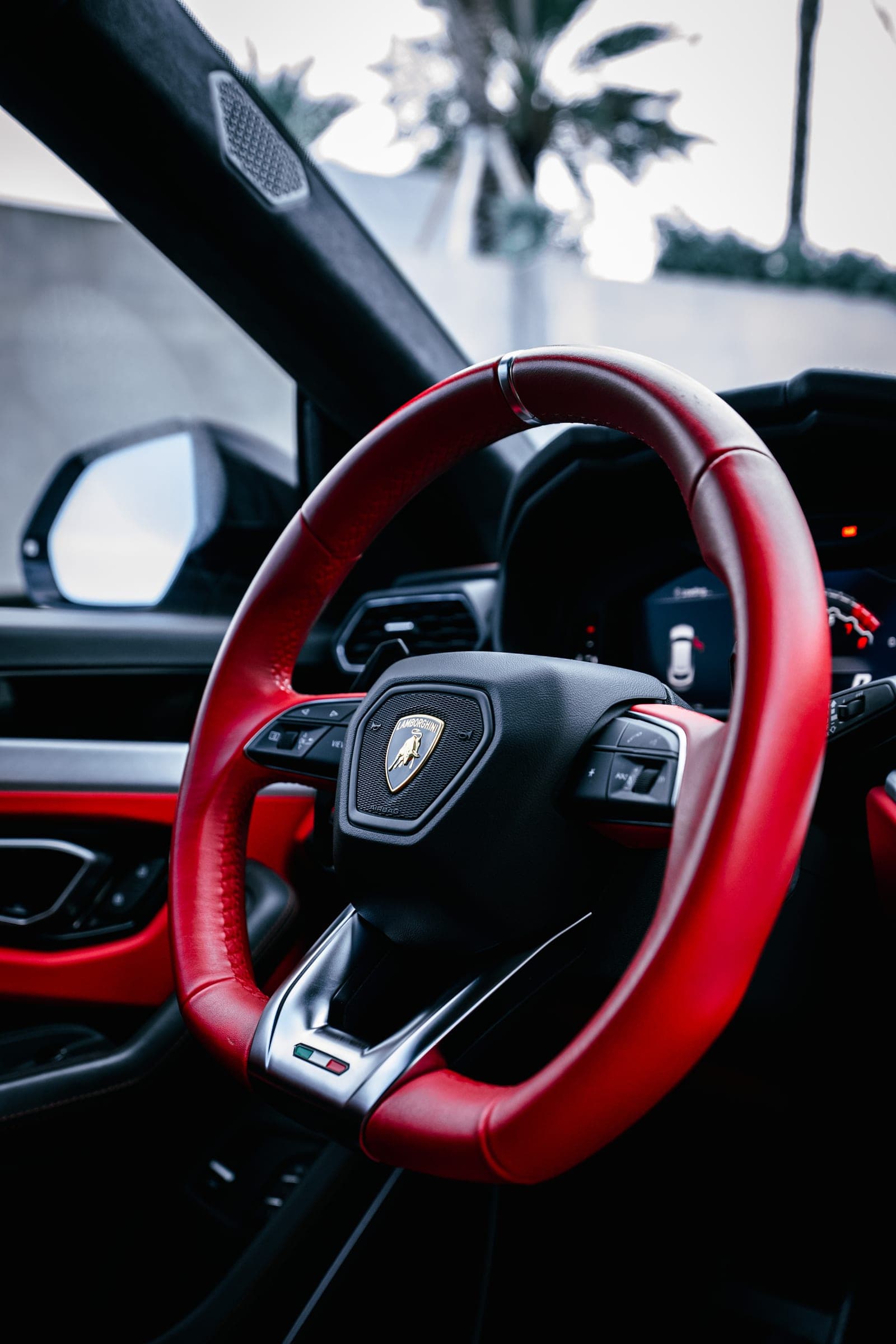 Red steering wheel detail in a Lamborghini Urus