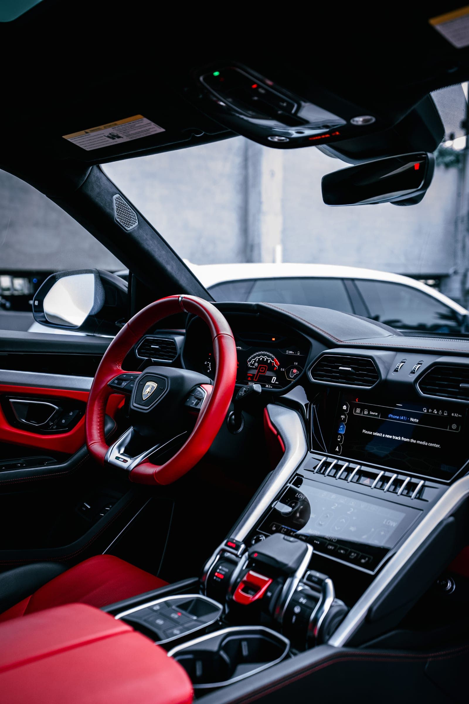 Red leather center console and gear selector in a Lamborghini Urus