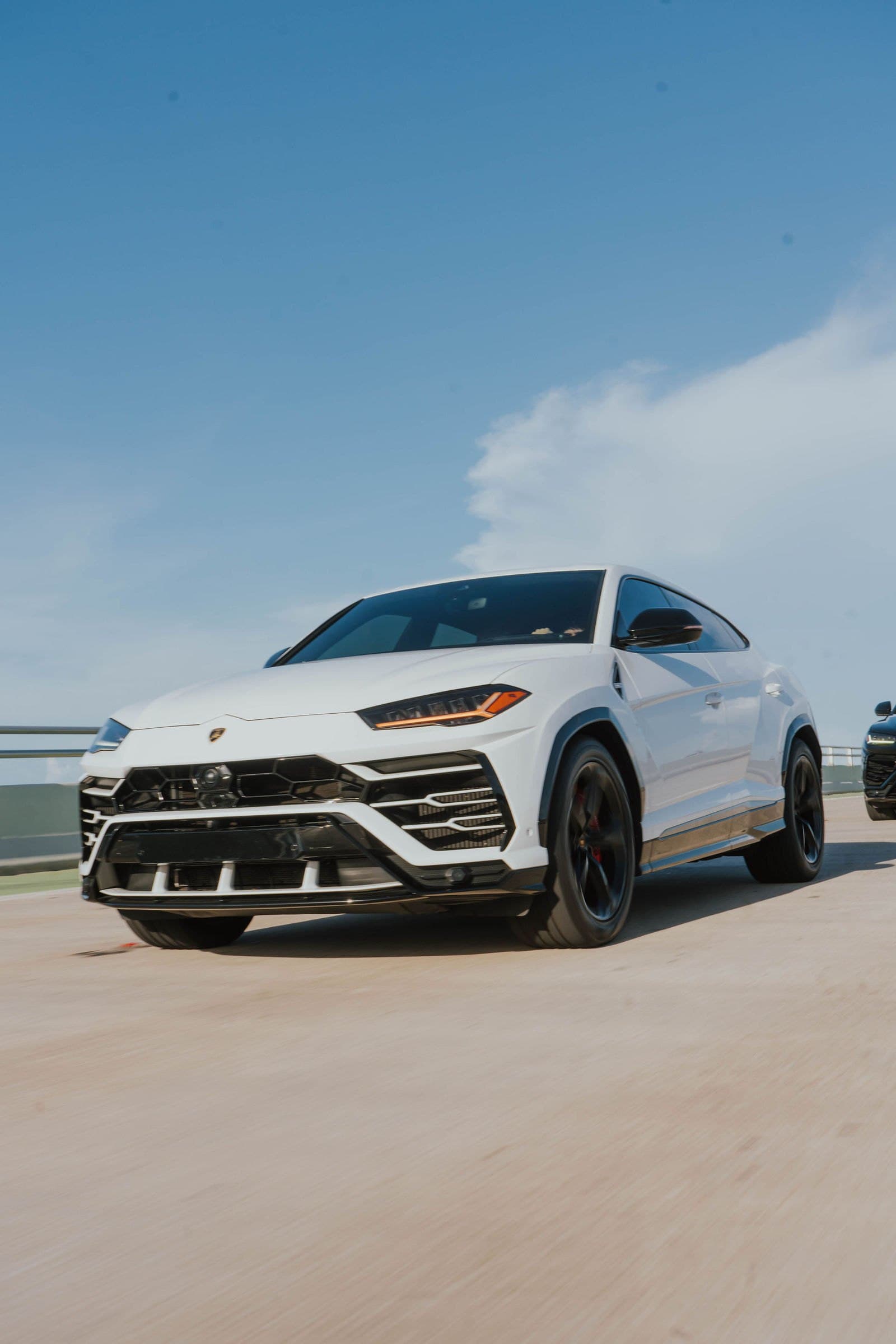 White Lamborghini Urus rolling shot on a Miami bridge